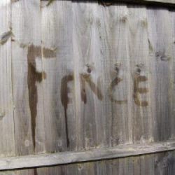 the word fence written on a fence in water