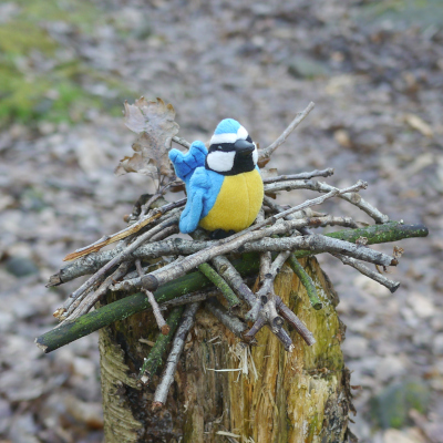 toy bird on nest made of sticks