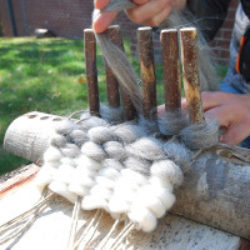 Setting up and weaving with a rustic peg loom