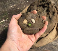 Mud clay face in hand