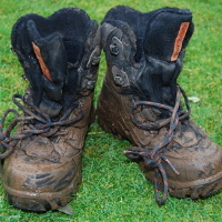 a pair of very muddy boots