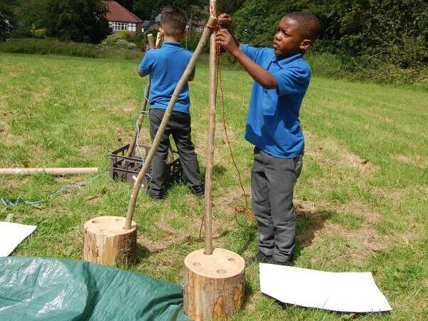 Two primary aged children exploring den play resources.