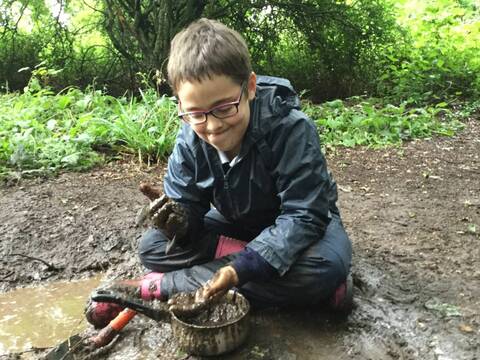 Charlotte has global developmental delay & mild learning difficulties. She found her passion when she was introduced to mud play. She spends most of her time at Forest School making mud cake, mud soup, mud biscuits - anything she fancies! / Julia Wilson.