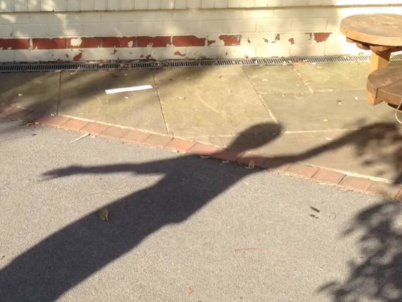 Child's shadow engaged in shadow dancing activity.